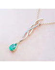 14K yellow gold twisted slider necklace with a pear-shaped emerald and diamond accents.