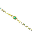 14K yellow gold bracelet with a central oval emerald and smaller emerald accents.