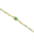14K yellow gold bracelet with a central oval emerald and smaller emerald accents.
