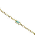 14K yellow gold bracelet with a central emerald-cut natural Colombian emerald and accent diamonds.