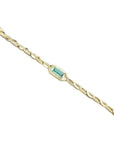 14K yellow gold bracelet with a central emerald-cut natural Colombian emerald and accent diamonds.