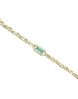 14K yellow gold bracelet with a central emerald-cut natural Colombian emerald and accent diamonds.