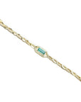 14K yellow gold bracelet with a central emerald-cut natural Colombian emerald and accent diamonds.