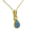 Pear-shaped Australian doublet opal pendant with bluish-green sparkles, bezel set in 14K yellow gold.