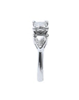 14K white gold ring with a princess cut diamond flanked by two trillion side diamonds.