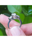 14K white gold ring with a princess cut diamond center and two trillion side diamonds.