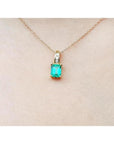 14K yellow gold pendant with a rectangular Colombian emerald and diamond accents on a delicate chain.