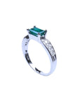0.90 ct. east west emerald ring in 14k white gold with side diamonds.
