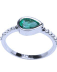 The top and side profile view of a teardrop emerald bezel set ring with accent diamonds in white gold.