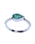 14K white gold ring with a bezel-set east-west teardrop emerald and prong-set accent diamonds.