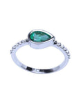 14K white gold ring with a bezel-set east-west teardrop emerald and prong-set accent diamonds.