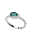 14K white gold ring with a bezel-set east-west teardrop emerald and prong-set accent diamonds.