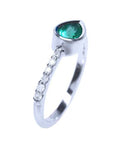 A teardrop emerald bezel set with accent diamonds ring in white gold top and side profile view.