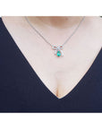 Emerald bow tie necklace, pear-shaped 1.28 ct. deep green emerald, 18K white gold.