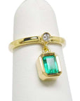 Front position of an emerald dangle ring representing May's birthstone jewelry.