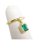14K yellow gold ring with a bezel-set emerald dangle and a small round diamond accent.