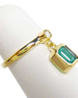A natural emerald dangle ring representing May's birthstone jewelry in 14k yellow gold.