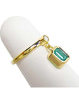 A natural emerald dangle ring representing May's birthstone jewelry in 14k yellow gold.