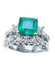 Top view of an emerald ring with a diamond matching band set in white gold.