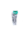 Side profile of a bridal's emerald engagement ring and matching wedding band white gold.