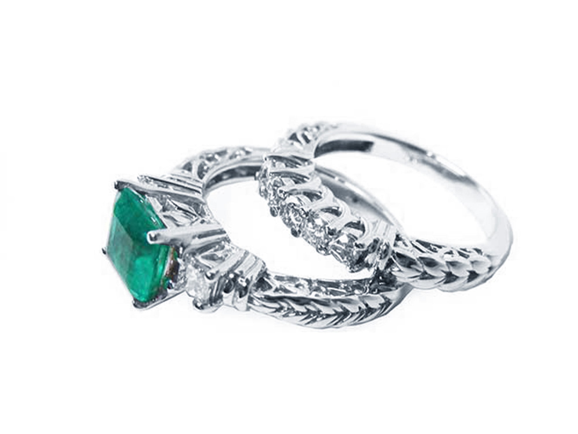 Emerald ring and diamond wedding band on lateral position.