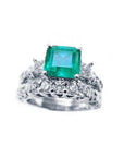 A Muzo Colombian emerald ring with a diamond matching band set in white gold.