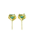 Pair of 14K yellow gold halo emerald stud earrings with vibrant green gemstones.