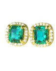 Pair of emerald stud earrings with halo diamond in yellow gold on a front position top view.