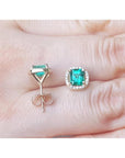 1.55 carat emerald halo diamond stud earrings in 14K yellow gold, one front view, one back view.