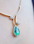 Gift for Mother's Day emerald necklace sourced from the Muzo mines, encircled by a halo diamond set in 18k yellow gold