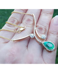 18K yellow gold necklace with a pear-shaped Colombian emerald and diamond clusters.