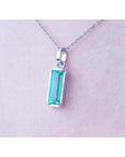 1.70 ct. rectangular Colombian emerald solitaire pendant in 14K white gold on a chain.
