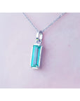 1.70 ct. rectangular Colombian emerald solitaire pendant in 14K white gold on a chain.