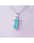 1.70 ct. rectangular Colombian emerald solitaire pendant in 14K white gold on a chain.