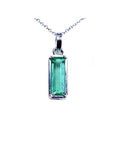 A solitaire emerald pendant on a white gold chain showing the topside view