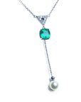 Colombian emerald necklace and freshwater pearl dangling from a triangle shaped gold with pave diamonds center piece