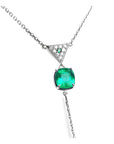 Natural cushion cut emerald necklace prong set in 14k white gold, dangling from a triangle shaped gold with pave diamonds center piece