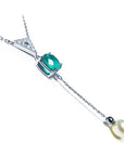 Emerald necklace cushion cut prong set in 14k white gold, dangling from a triangle shaped gold - fresh water pear dangling from the emerald