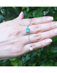 1.91 carat emerald cushion cut necklace with a hanging white freshwater pearl on 14K white gold.