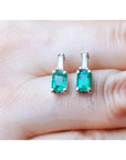 Colombian emerald and baguette diamond stud earrings, 14K white gold.