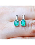 Colombian emerald and baguette diamond stud earrings, 14K white gold.
