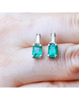 Colombian emerald and baguette diamond stud earrings, 14K white gold.