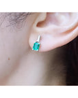 Colombian emerald and baguette diamond stud earrings, 1.10 ct., set in 14K white gold.