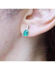 Colombian emerald and baguette diamond stud earrings, 1.10 ct., set in 14K white gold.