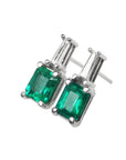 A pair of Colombian emerald and baguette diamond stud earrings, left side profile view.