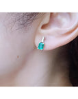 Colombian emerald and baguette diamond stud earrings, 14K white gold.