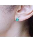 Colombian emerald and baguette diamond stud earrings, 14K white gold.