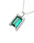 This emerald and baguette diamond pendant necklace is displaying the topside view.