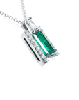 A white gold emerald baguette pendant with accent diamonds displaying the right-side gallery profile view.