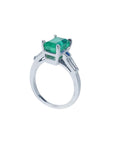 18K white gold ring with a rectangular deep bluish-green emerald and baguette side diamonds.